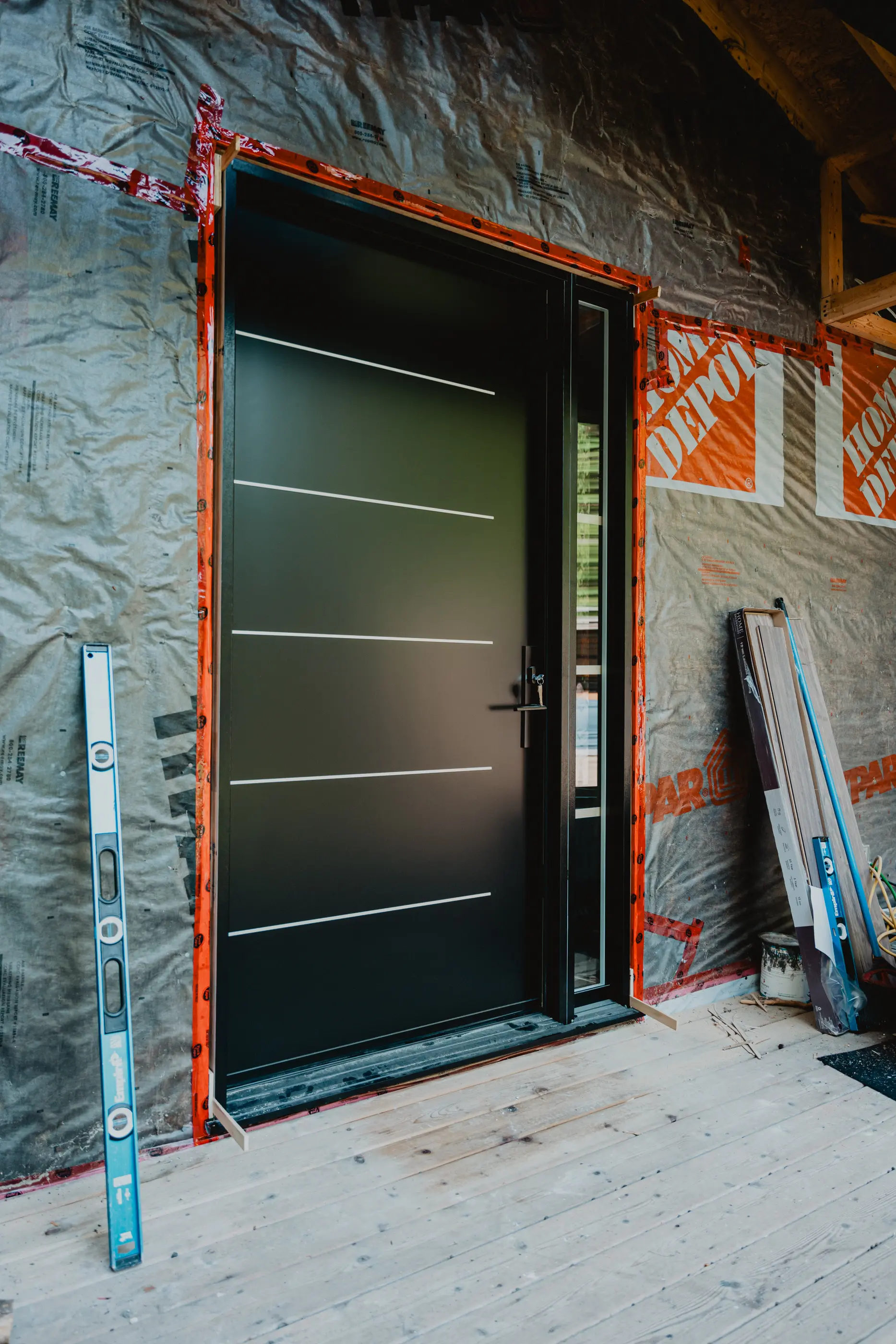 Modern black door under construction.