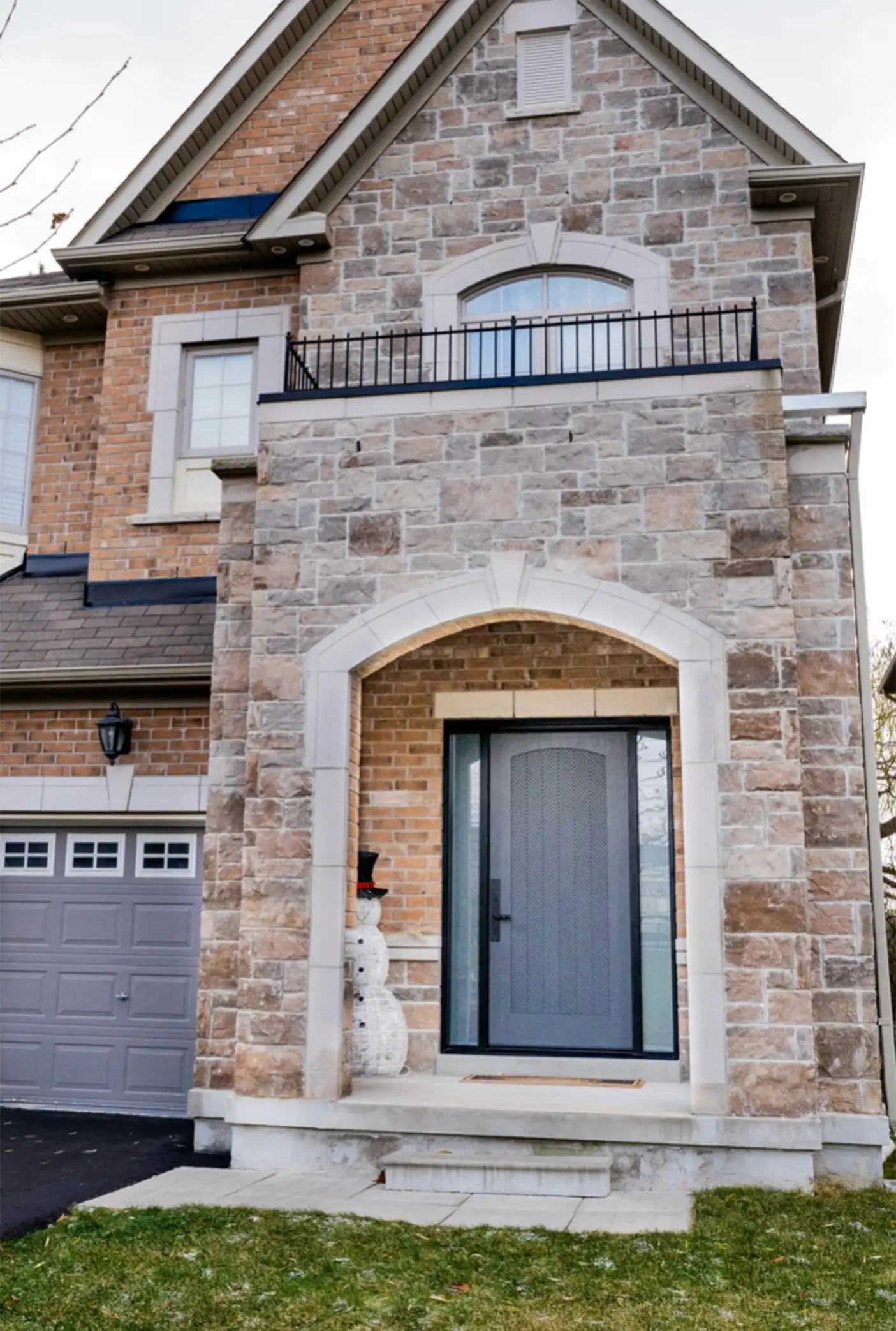 Stone brick house with arched entry.