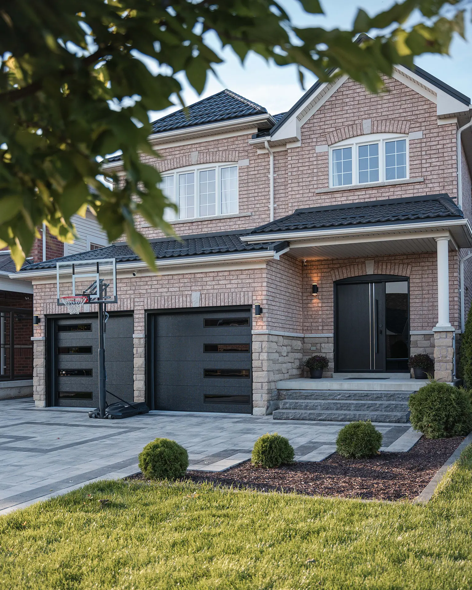 Matching garage door and entry door with a modern, cohesive design, featuring clean lines and a sleek finish for a unified exterior look.