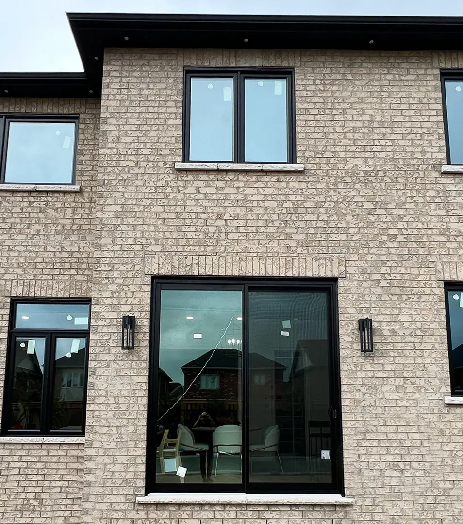 house with new stylish black windows, giving a modern and elegant look to the facade.