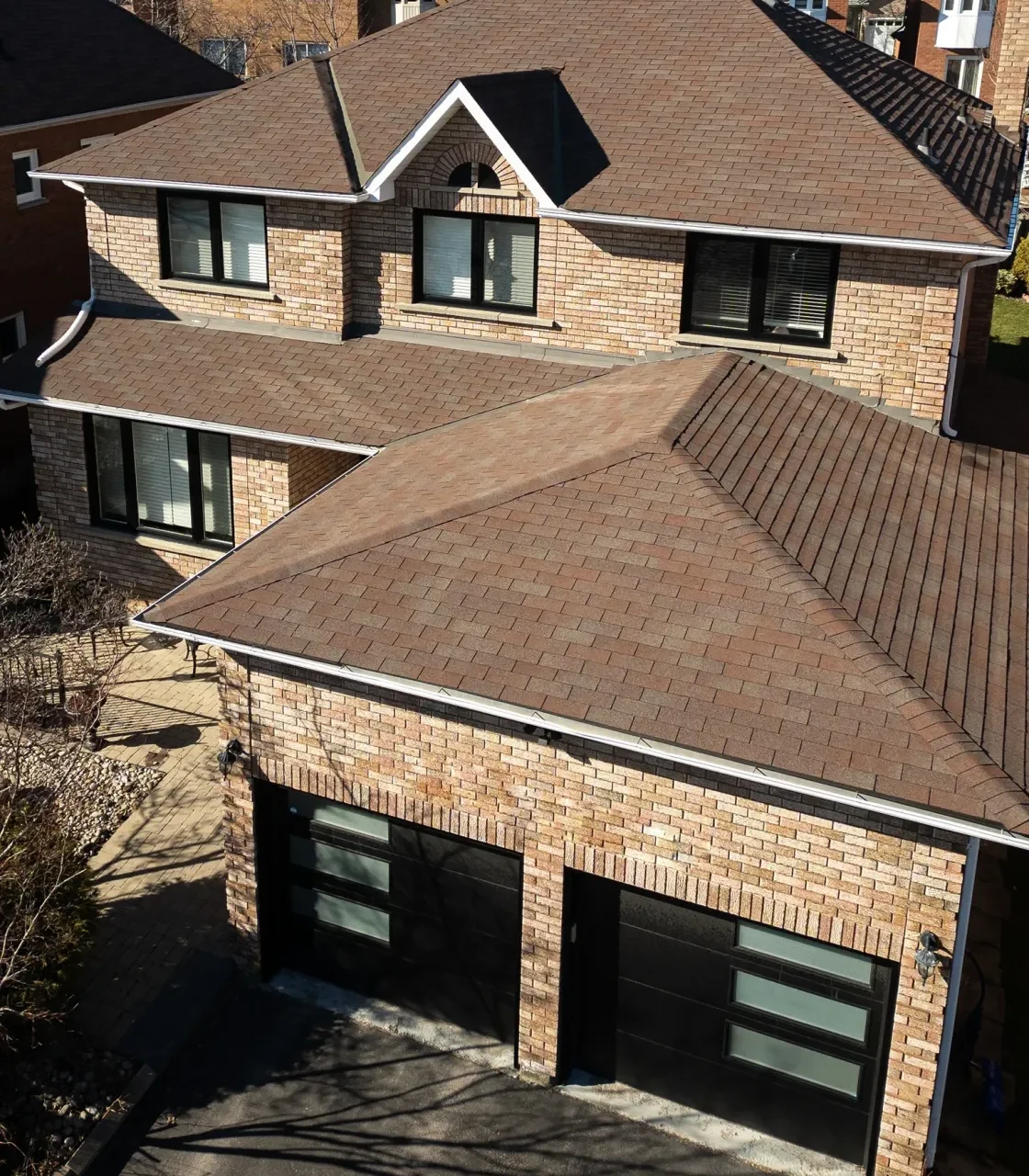 Aerial view of a home with two new black garage doors