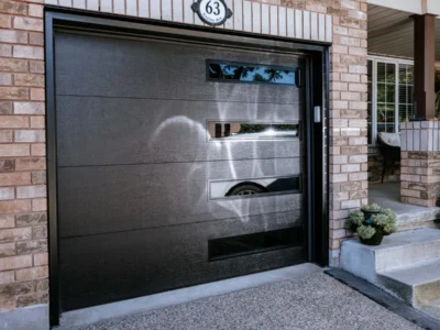 Black insulated garage door with a row of windows