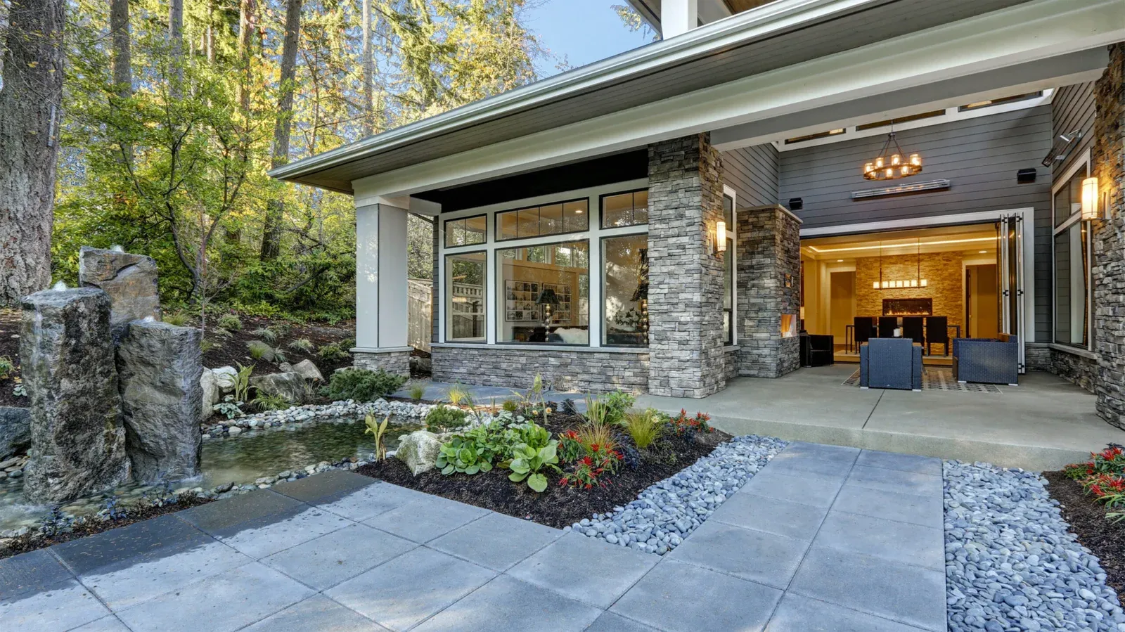 Folding glass wall opening a living room onto the terrace
